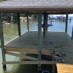 Custom Dock with Shingle Roof covering and standing bar on piling