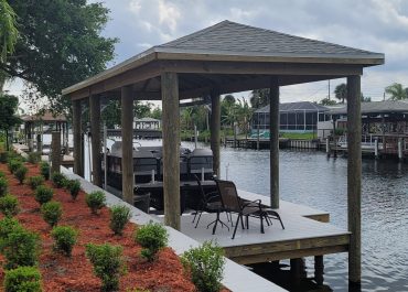 New vinyl seawall, composite decking and boat house with lift