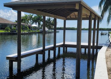 Custom boat dock with skinny decking and boat house roof