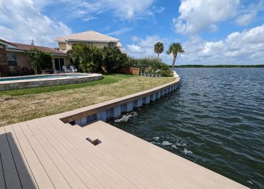 Curved seawall level with grass backyard